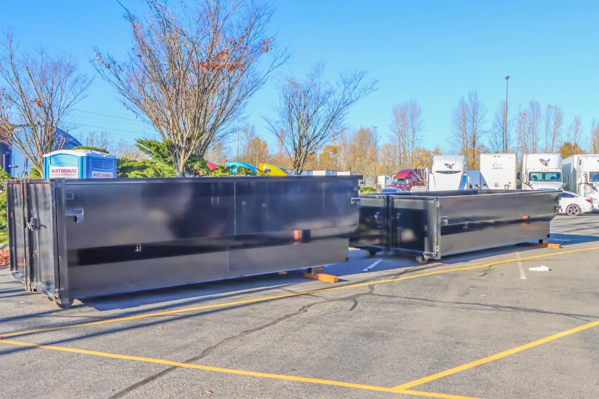 Professional dumpster rental service with roll-off container on residential driveway in Englewood